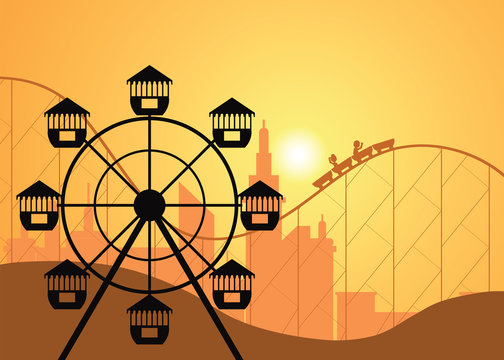Silhouettes of a city and amusement park with the Ferris wheel .