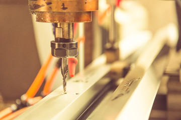 closeup of drilling machinery with cooling tube in factory,blurred background.