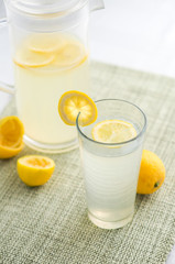 Fresh lemonade vertical view.  Lemonade is traditionally a homemade drink made with squeezed lemon, water and sugar, a simple recipe for a quick refreshing summer drink packed with vitamin c.