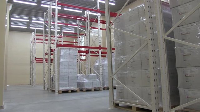 Warehouse at the Enterprise or Factory with Shelves and White Sacks and Boxes