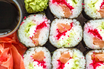 The plate of sushi with soy sauce, wasabi