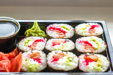 The plate of sushi with soy sauce, wasabi