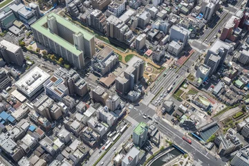 Schilderijen op glas Tokyo urban area with streets and buildings, aerial view, Japan © marchello74