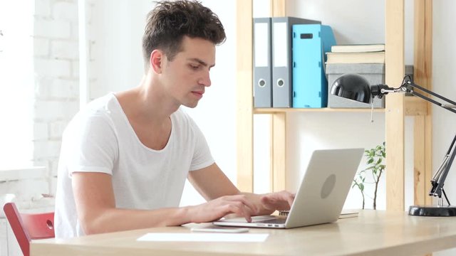 Creative Designer Typing On Laptop in Office