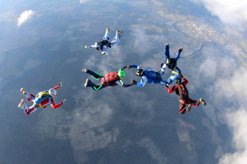 Fototapeta na wymiar Skydivers are flying in the sky