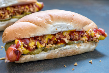 Grilled hot dogs with mustard, ketchup and dill pickles