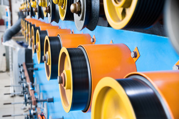 Rotating rubberized wheels of the winding machine.