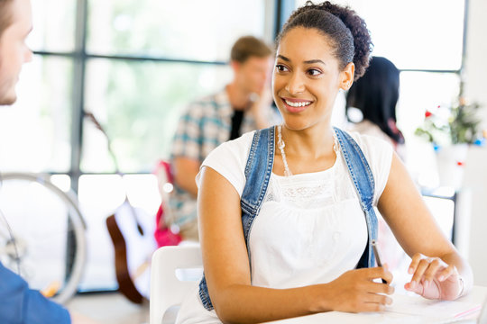 Portrait of smiling afro-american office worker sitting in offfice