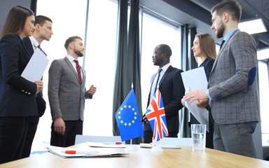 European Union and United Kingdom leaders shaking hands on a deal agreement.