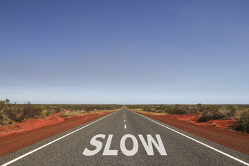 Slow written on the road