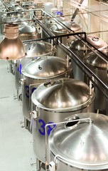 A number of glossy steel cylindrical tanks.