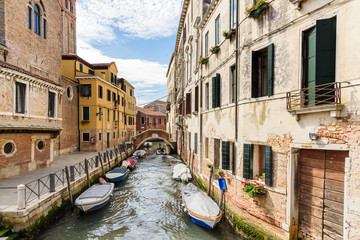 houses and boats along the canal of Venice, Italy