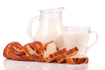jug and glass of milk with a loaf of bread isolated on white background