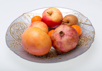mix fresh fruits on plate isolated on white