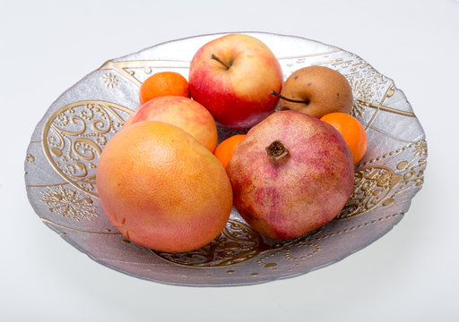 mix fresh fruits on plate isolated on white