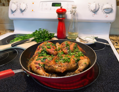 Whole Chicken In Frying Pan On Hot Stove Top