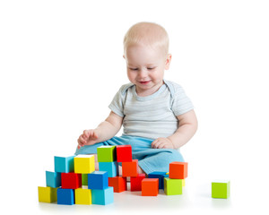 Kid building from toy blocks. Isolated on white background