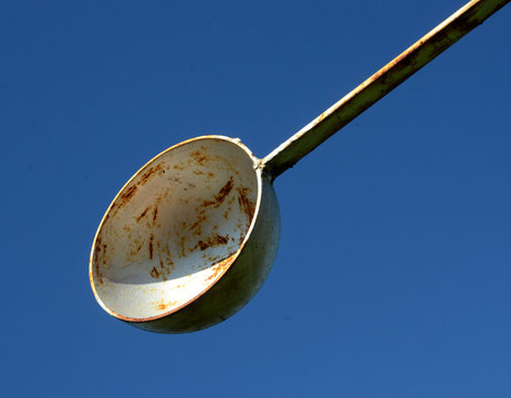 The concave cup side of a savonius rotor seen towards the blue sky.