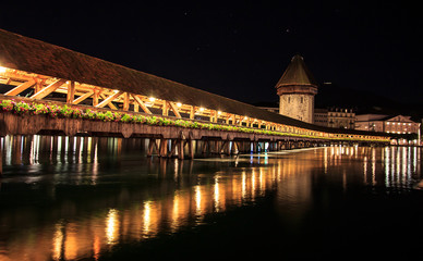 Chapel Bridge and Water Tower at night with reflection on the lake, Lucerne, Switzerland