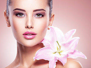 Beauty pure face of the young beautiful girl with flower