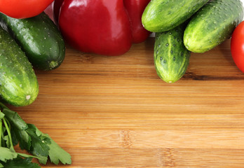 tomatoes, peppers ,cucumbers and parsley on a cutting Board