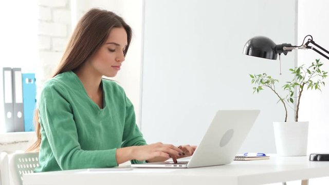 Beautiful Woman Working On Laptop in Office