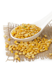 Dry yellow split peas isolated on white.