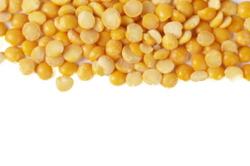 Dry yellow split peas isolated on white.