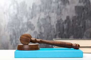 Wooden gavel and books on wooden table