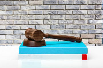 Wooden gavel and books on wooden table