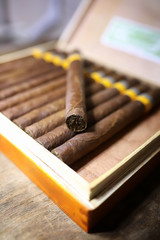 Large box of Cuban cigars on a wooden table