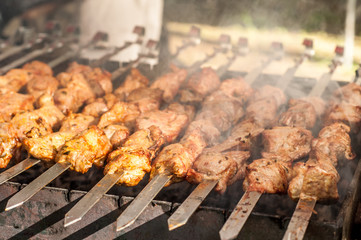 Shish kebab on skewers is fried on a grill