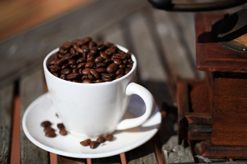 Old coffee grinder and coffee beans close-up.