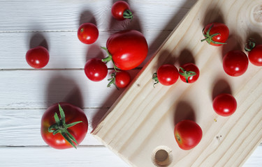 Fototapeta na wymiar harvest fresh tomato top on wooden background