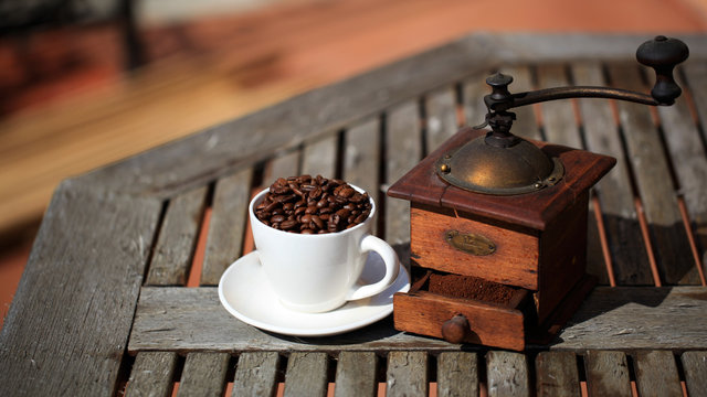 Old coffee grinder and coffee beans close-up.