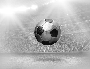Soccer player with ball in action on field of stadium
