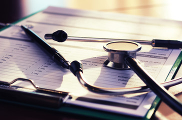 cardiologist stethoscope paper insurance