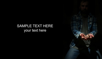 black background with bullet in hands man