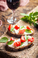 Crostini appetizers with cherry tomatoes, and cheese