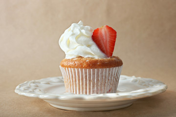 Cupcake with cream and strawberry