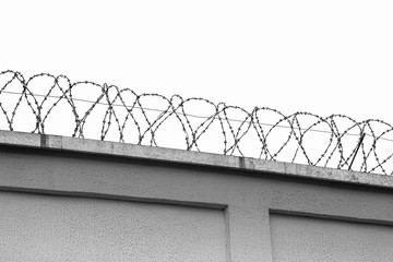 barbed wire fence on the background of clear sky