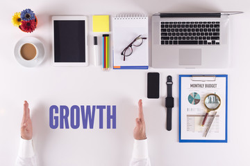 Businessman working on desk - hands showing GROWTH concept