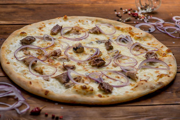 Pizza on a wooden background