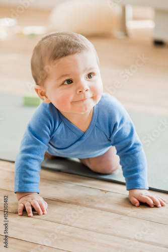 Funny Baby Boy Crawling On Yoga Mat And Smiling Funny Baby Boy Crawling On Yoga Mat And Smiling