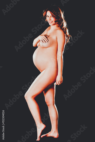 Red Hair Prego Nude - Side view of naked pregnant woman\