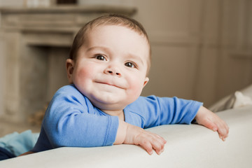 Portrait of funny baby boy looking at camera with smile