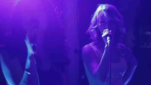 Beautiful charismatic two women singer performing at music event