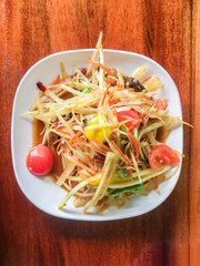 Pickled fish papaya Salad, Som tum, Thai food on wood table