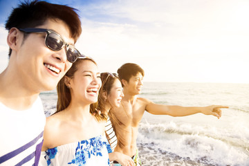 Fototapeta premium happy young group walking on the beach enjoy summer vacation