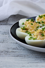 Home eggs stuffed with cheese and crab topped with green onions